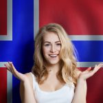 Norwegian concept with smiling happy cute girl with Norway flag background.